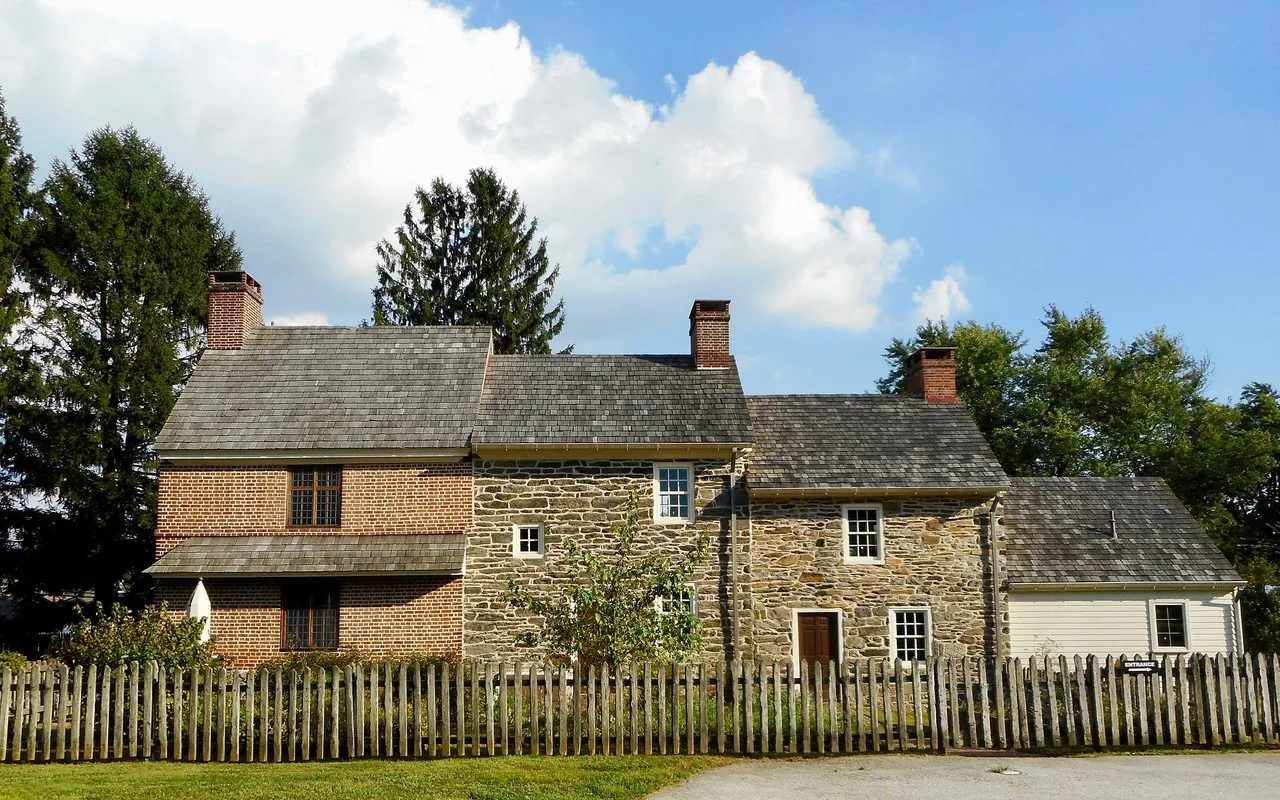 The Thomas Massey House in Broomall, a colonial farmhouse of brick and fieldstone behind a wooden picket fence