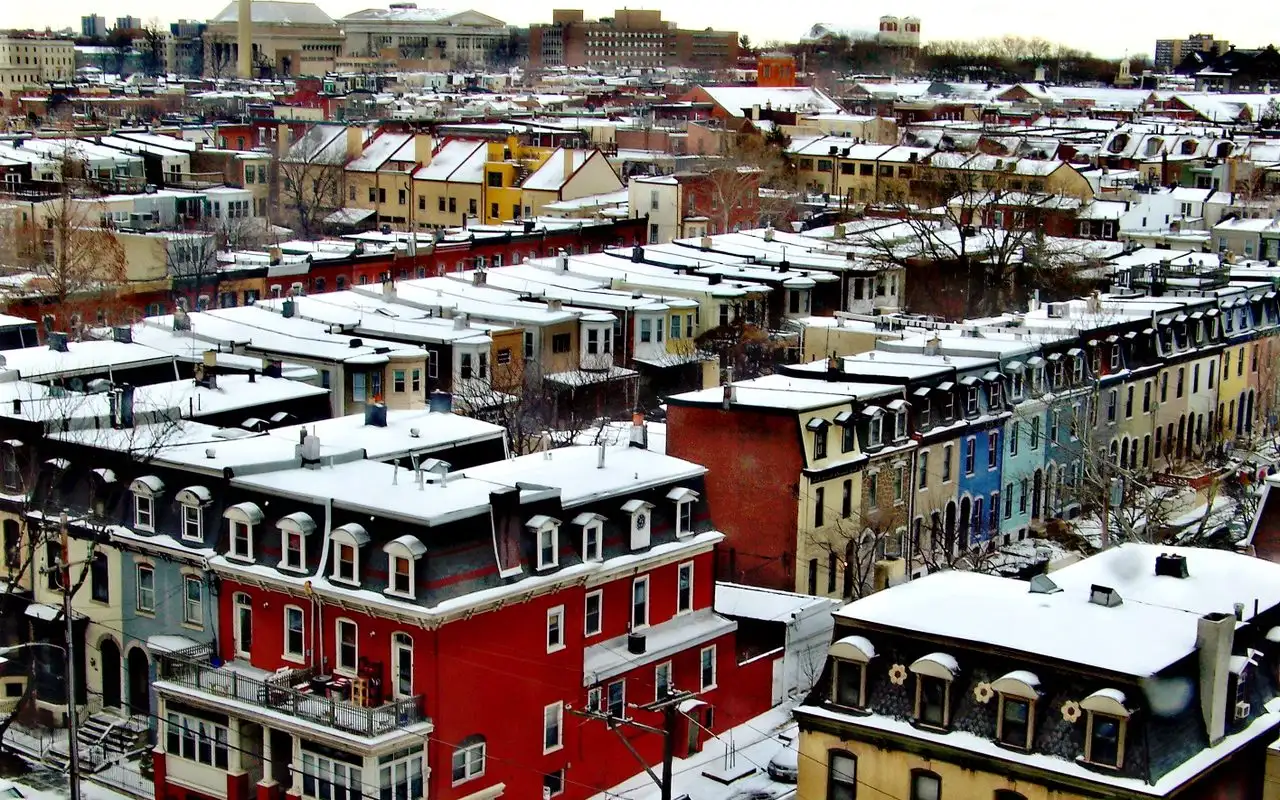Snow-covered rooftops of Fairmount rowhouses seen from above, looking northeast toward Girard College
