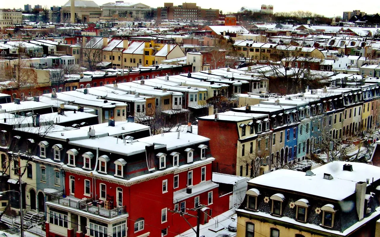 Snow-covered rooftops of Fairmount rowhouses seen from above, looking northeast toward Girard College