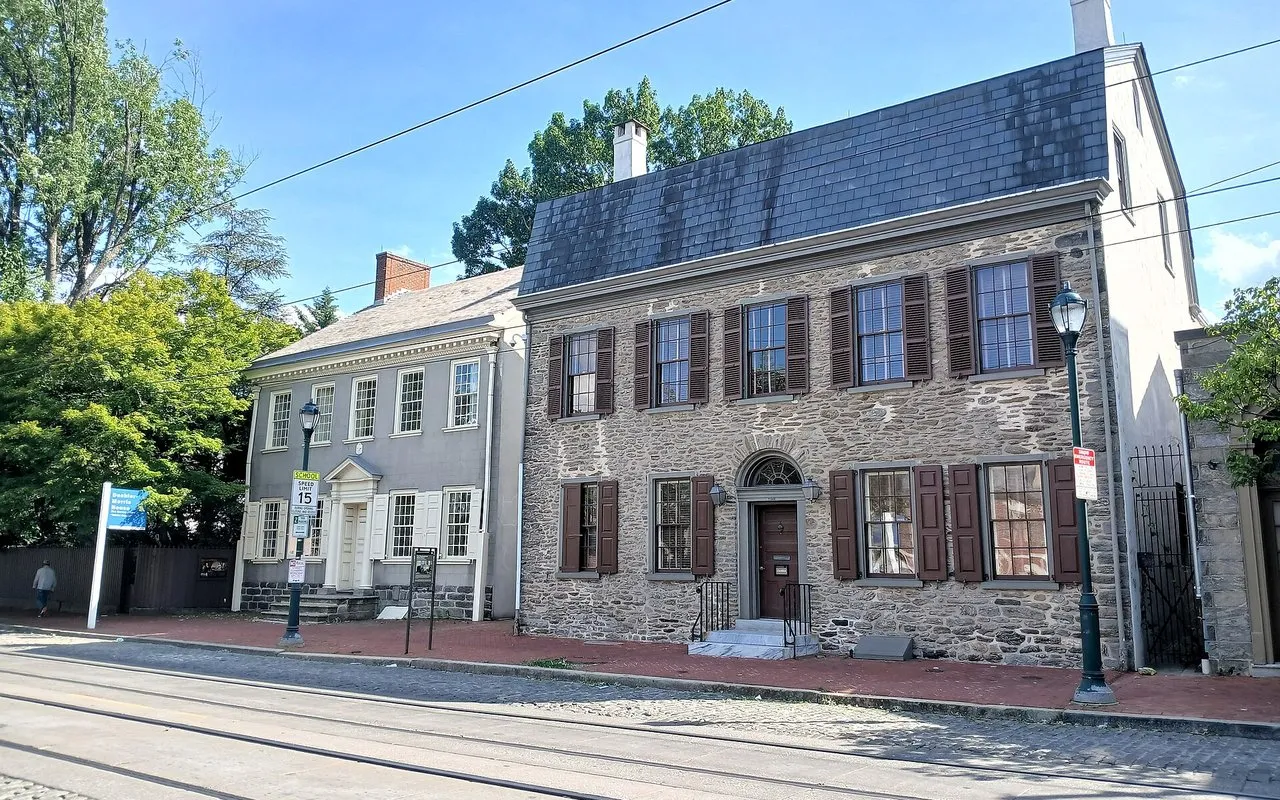 The stone Deshler-Morris House on Germantown Avenue, with trolley tracks in the street