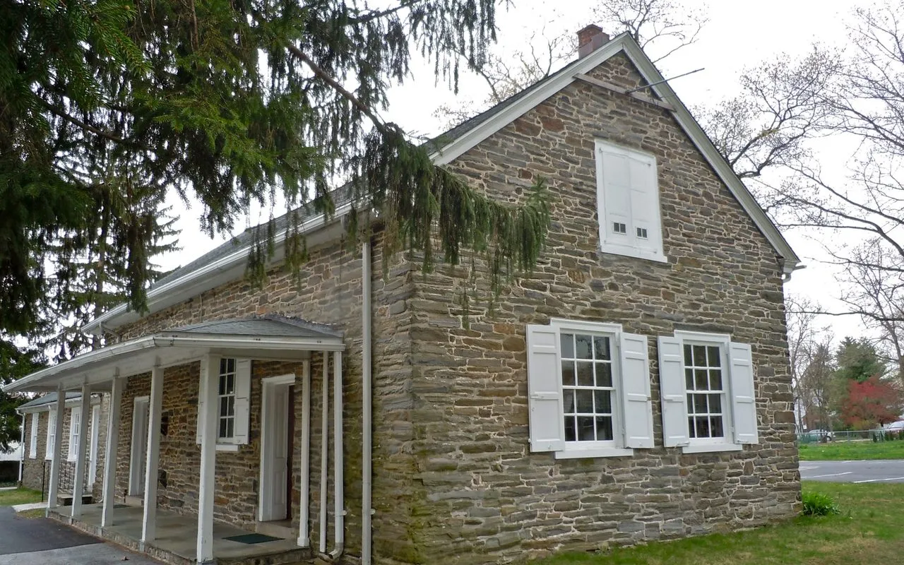 The Old Haverford Friends Meetinghouse, a fieldstone building with white shutters and a long front porch, on Eagle Road in Havertown