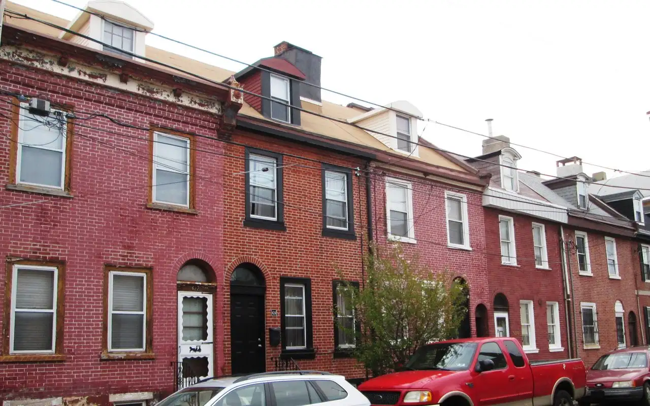 A row of brick rowhouses with dormer windows on North 4th Street in Northern Liberties